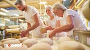 baker with a team baking a loaf of bread