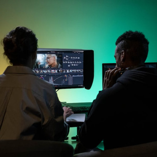 photo showing two people editing video