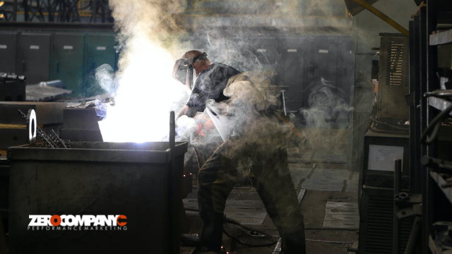 Man Wearing Welding Mask Covered in Welding Smokes