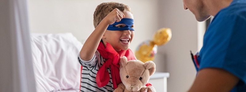 strong little boy wearing superhero blue