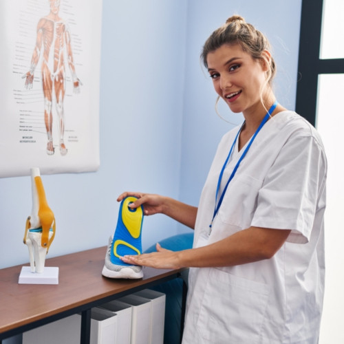 woman podiatrist holding insole