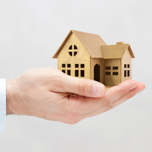 Golden house miniature in hand