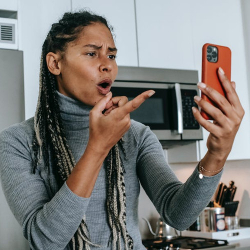 annoyed female holding cellphone