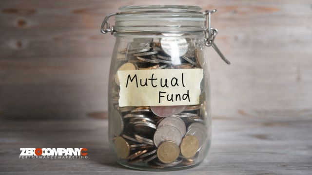 Coins in glass money jar with mutual fund label