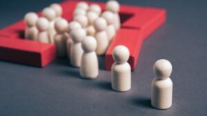 Conceptual image of a group enclosed within a red boundary while others remain outside